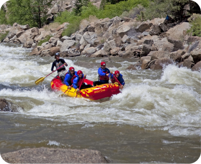 5 people in a red boat rafting on a fast river