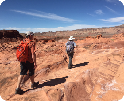 two people walking through the colorado canyon dressed as trekking